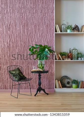 Room, wall, claret red background, decorative stone wall concept, modern book shelf and table in the room. Carpet chair vase of plant and middle table. Royalty-Free Stock Photo #1343811059