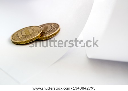 twenty rubles two coins on white paper, paper bends and copper coins of Russia