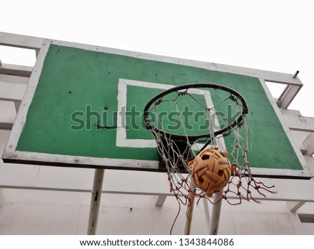 takraw ball in the basketball hoop