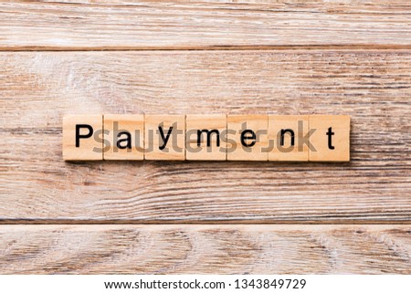 Payment word written on wood block. Payment text on wooden table for your desing, concept.