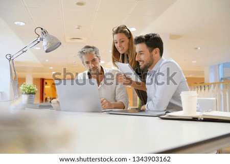 Startup team going through business ideas in office