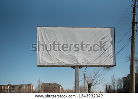 Blank white advertising banner on a street in the city