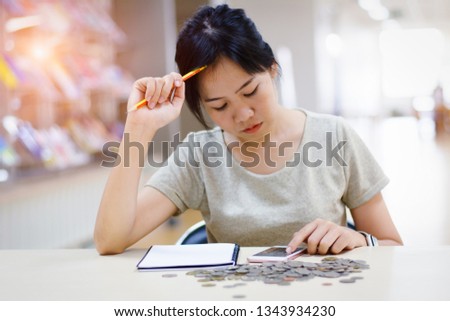 Asian  woman hand holding pencil and using smart phone for shopping online