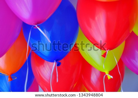 Flying colorful party balloons in the room. Multicolor helium balloons. Detail picture. Celebration. Colorful background.