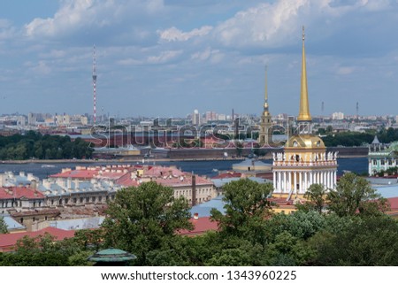Admiralty spire and Peter and Paul fortress, view of the Neva river and residential buildings of St. Petersburg from a height.