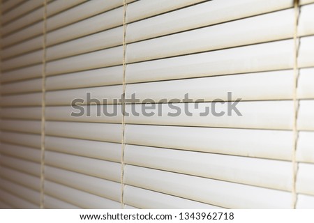 dirty window blinds covered with dust