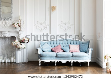 Livingroom interior  mock up with blue  velvet sofa and pink pastel  pillows on white wall background with free space. - Image       Royalty-Free Stock Photo #1343982473