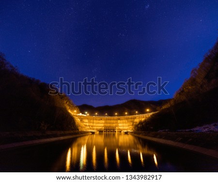 Dam lake under starry night sky