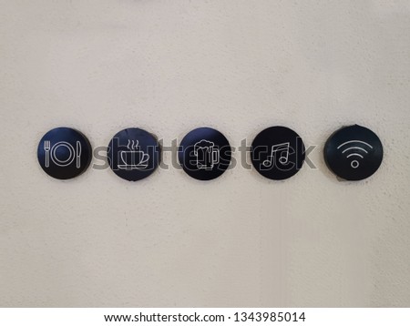 The sign indicated "Restaurant, Coffee, Beer, Music and internet wifi." The wall is showing useful symbols for lifestyle.  
