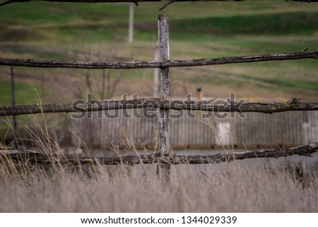 Fence of branches. Remote countryside. Picturesque places. The creation of man. Rural fence