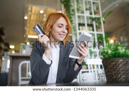 Business woman with credit card and tablet computer