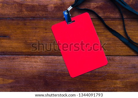 Empty red blank of badge on stylish wooden background. Great mock up for designers artwork.