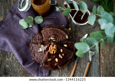 Homemade chocolate pancakes with chocolate sauce