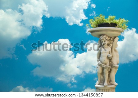 Angel statue and blue sky, Sculpture of cupid,Little child plant pots and blue skies with clouds