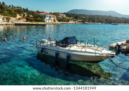 Wonderful summer day of Zavalata Beach, Fiskardo village. Kefalonia island, Greece, Europe. Beautiful Spring view on seascape with Incredible  turquoise water and sport luxury boat 