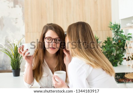 Two best friends girls having fun drink coffee, smiling and gossip, joyful sisters celebrating birthday party, elegant stylish clothes