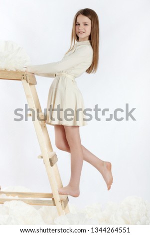 Young girl in a creamy dress, stuio photo