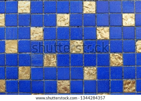 Blue and gold ceramic wall and floor tile abstract background.