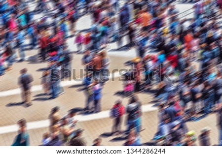 Conceptual motion blur picture of a large anonymous crowd.