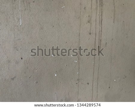 The Texture Green Wall cracks.Image is pastel tone.The old cement wall There are water stains and algae are.A concrete road surfaces with stones and sand and traces of use road.