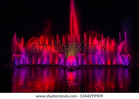 The colorful fountain dancing in celebration festival with dark night sky background.