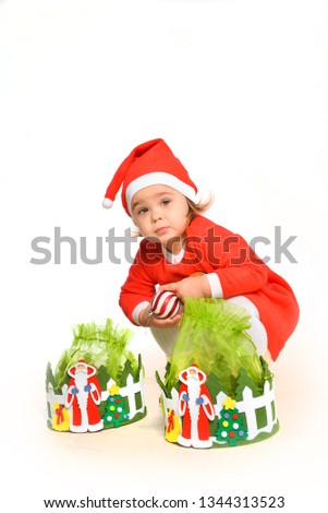 emotional kid girl in a red santa costume posing on white isolated background in new year holiday