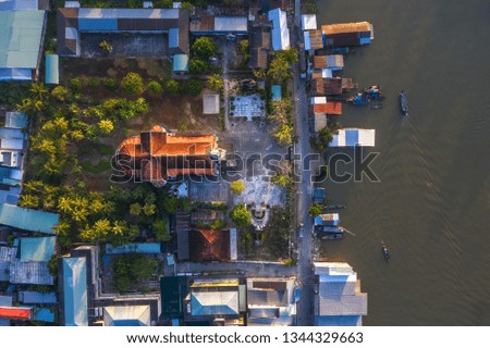 Aerial view of the famous Cai Be church in the Mekong Delta, Roman architectural style. In front is Cai Be floating market on Tien Giang river, Vietnam