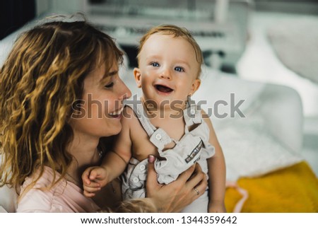mom hugs and kisses little son