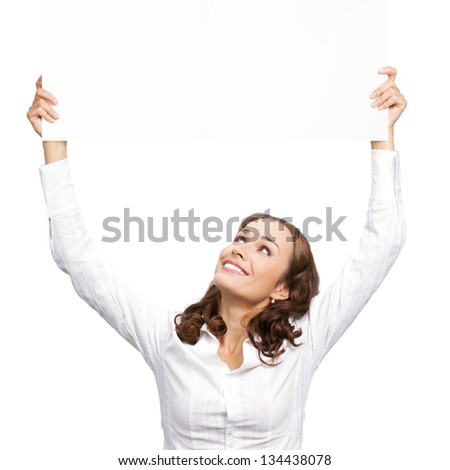 Happy smiling young business woman showing blank signboard, placard or banner, isolated over white background