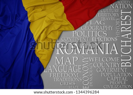 waving colorful national flag of romania on a gray background with important words about country . concept