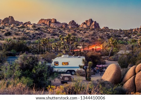 Image of a campground at Joshua tree national park during sunset with a RV or caravan placed
