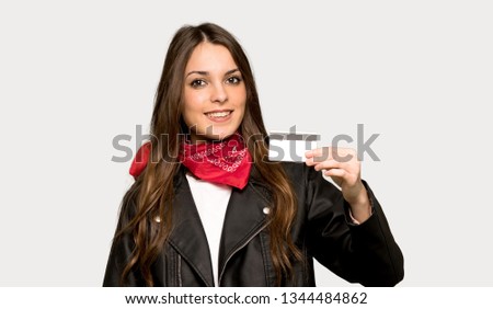 Young woman with leather jacket making a selfie over isolated grey background