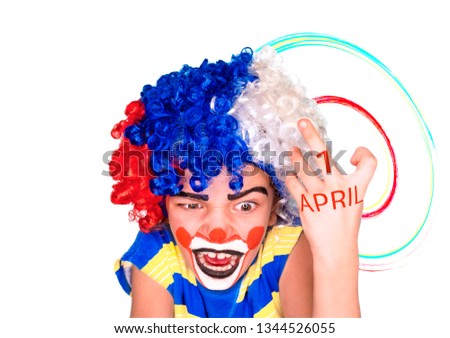 angry evil clown face. little cute boy with face paint like clown and with an inscription on April 1 on his hand, pantomimic expression. emotions. April Fool's Day, April 1. Isolated on white.