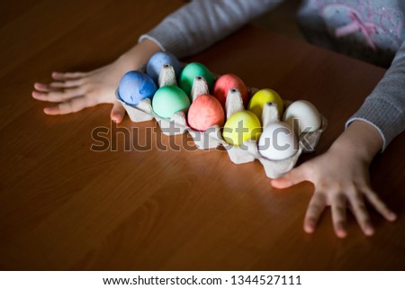 Happy easter. Little girl painter painted eggs. Kid preparing for Easter. Painted hand. Finger paint. Art and craft concept. Traditional spring holiday food