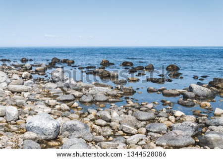 Scandinavian seaside. Stones and blue water in Oland, Sweden.