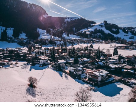 Mountain town called kitzbuehel on a sunny blue sky day view towards the hahnenkamm