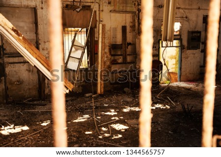 Destroyed office in abandoned building. Sun rays light up messy apocalyptique interior. 