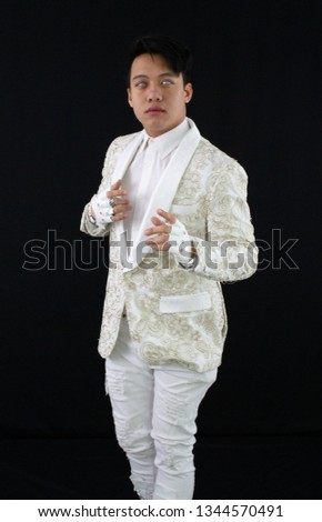 Magical man in white suit on black background