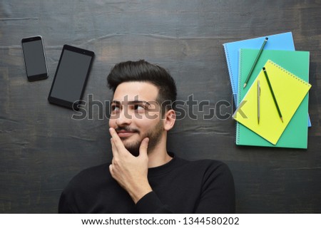 Young man choice internet or studying (screens have clipping path)