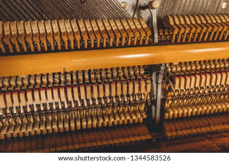Inside a piano ,showing a vintage wooden parts of piano in close up
