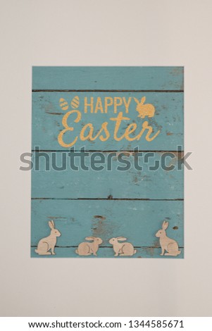 Passepartout with decorative objects in the form of rabbits and inscription Happy Easter
