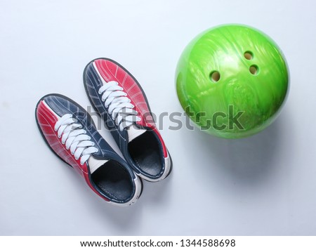 Bowling shoes and bowling ball on white background. Indoor family sports. Top view. Minimalism