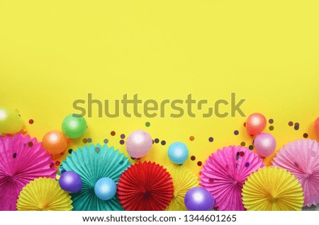 Paper texture flowers with confetti and baloons on yellow background. Birthday, holiday or party background. Flat lay style.