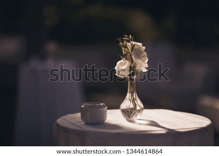 A bouquet of white flowers in a vase on a table