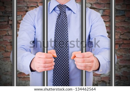 Businessman in jail. Royalty-Free Stock Photo #134462564
