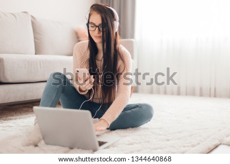 Young trendy woman blogger in cute pink girl room