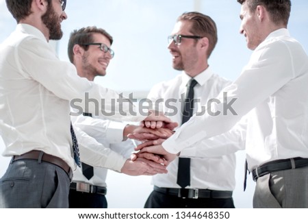 close up.a group of business people folded their hands together