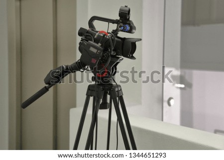 Modern professional HD video camera on a black tripod