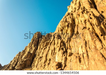 Middle East or Africa, picturesque bare mountain range and a large sandy valley desert landscapes landscape photography. Horizontal frame