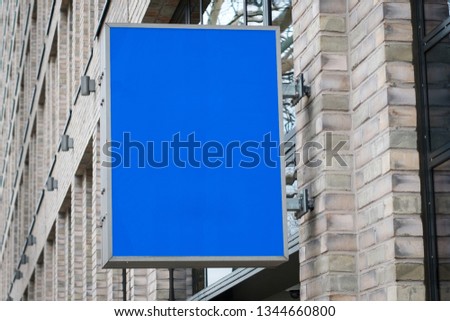 blank sign on building facade / empty shop mockup for advertisment  